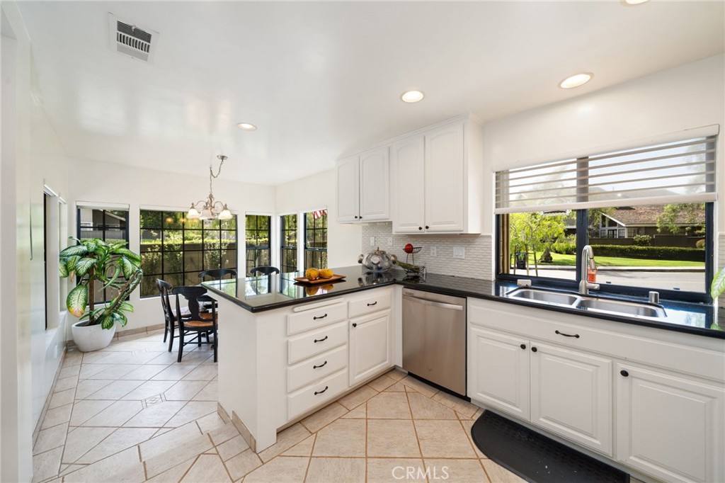 49 Pinewood, Unit 25 Irvine, CA 92604 - Photo 7 of 42 a kitchen with granite countertop a sink and cabinets