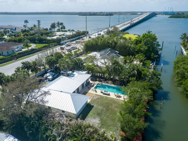 an aerial view of a house with a yard and lake view