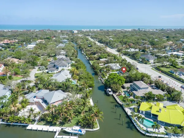 an aerial view of residential houses with outdoor space and river
