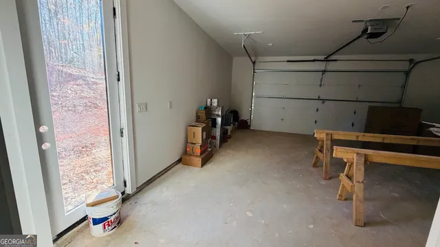 a kitchen with a refrigerator and white cabinets