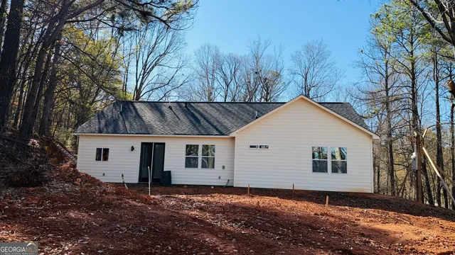 a view of a house with a snow in the yard