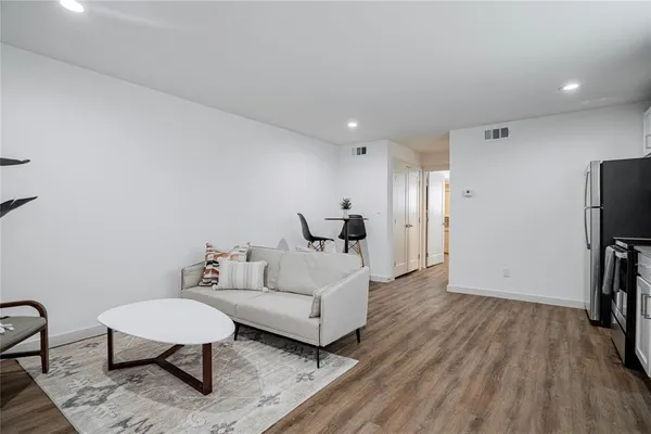 a spacious bedroom with a bed and a chair