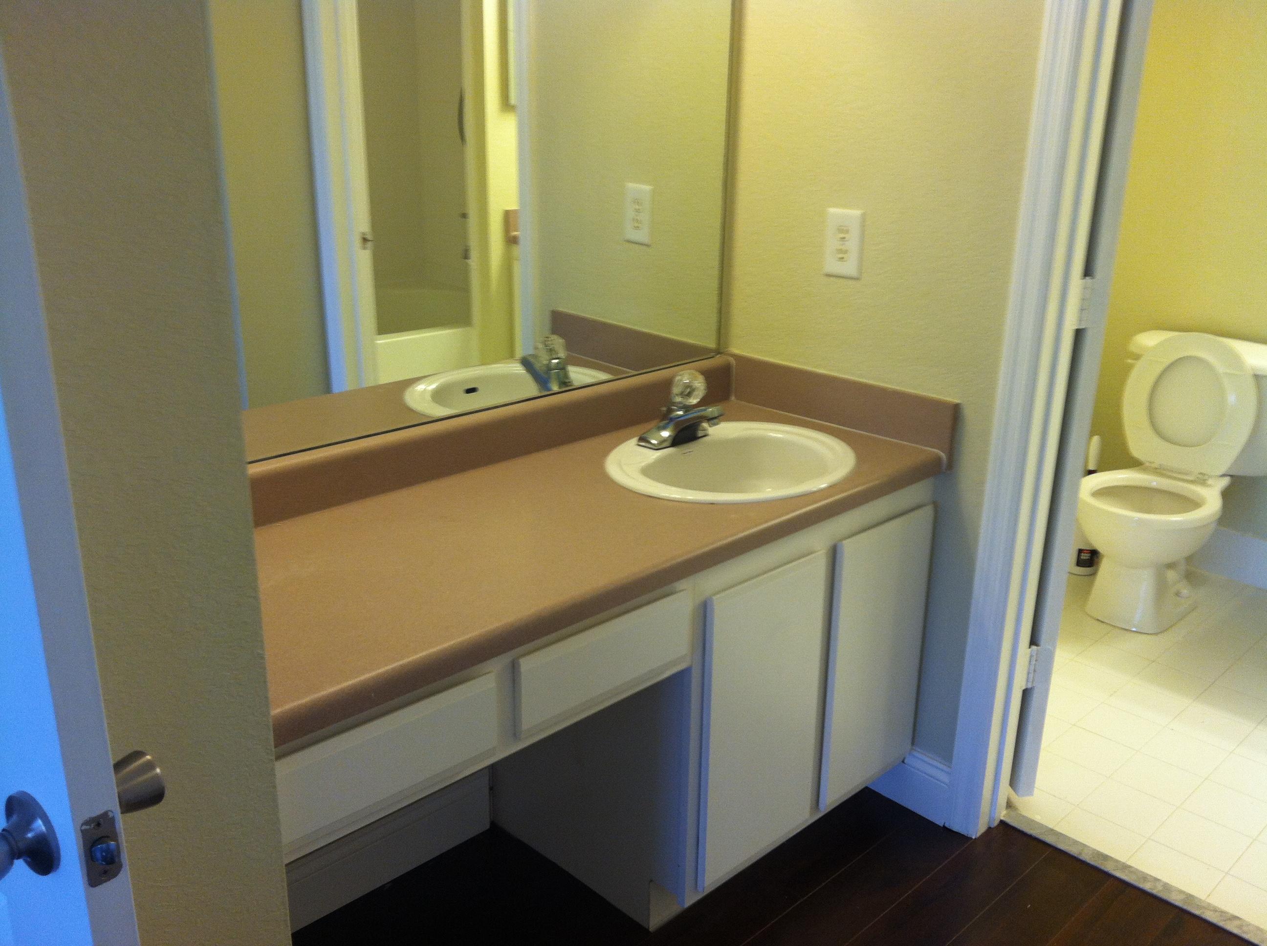 171 Southwest Palm Drive, Unit 205 Port St. Lucie, FL 34986 - Photo 2 of 8 a bathroom with a sink and a mirror