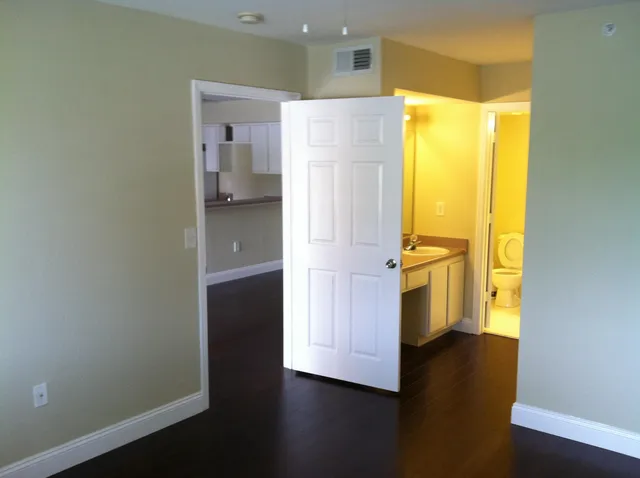 a view of walk in closet with wooden floor