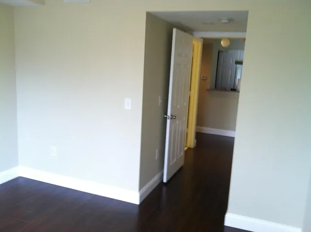 view of a hallway with wooden floor
