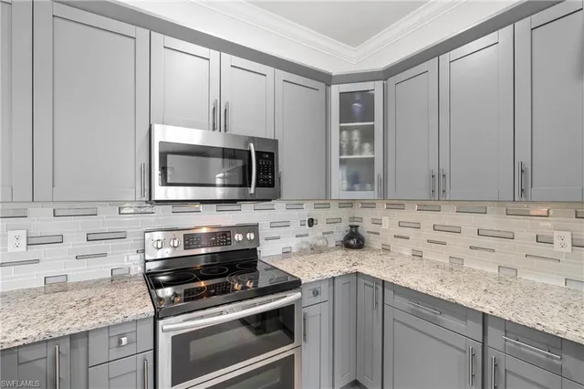 a kitchen with granite countertop cabinets stainless steel appliances and a sink