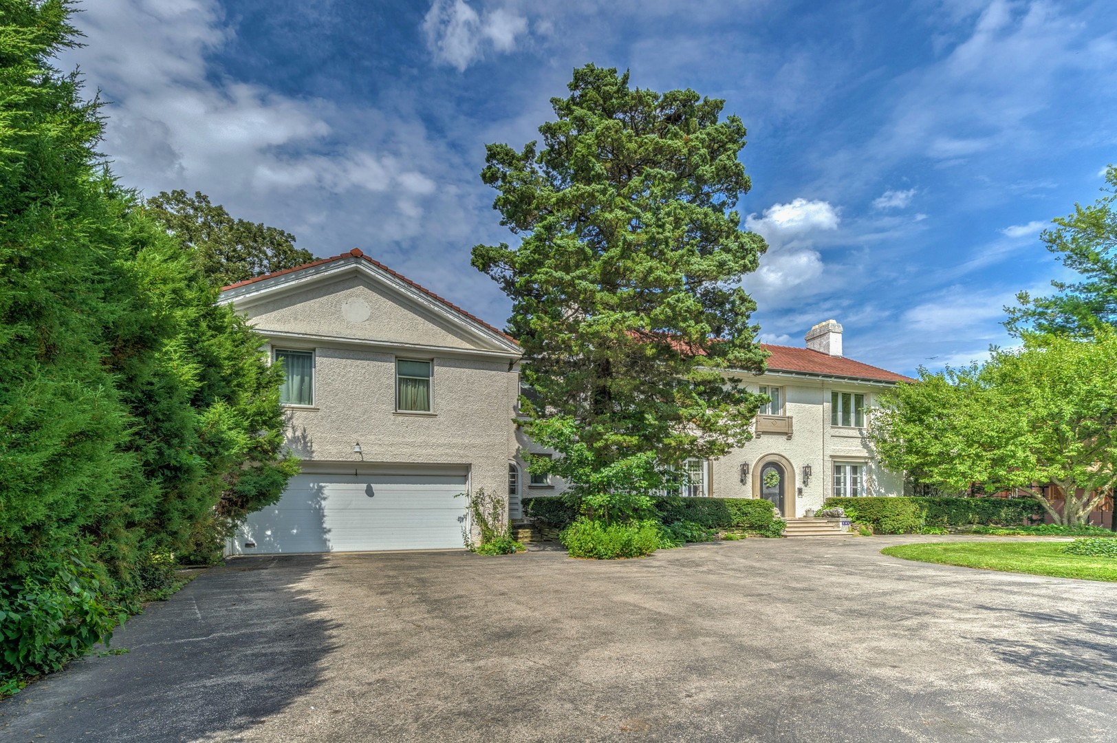 141 Sheridan Road Winnetka, IL 60093 - Photo 3 of 58 a front view of a house with a yard and garage