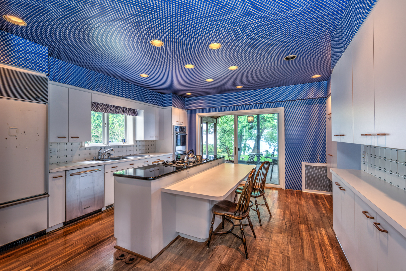 141 Sheridan Road Winnetka, IL 60093 - Photo 23 of 58 a kitchen with kitchen island granite countertop wooden floors and stainless steel appliances