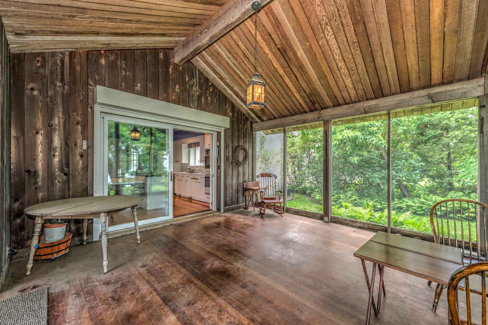 141 Sheridan Road Winnetka, IL 60093 - Photo 28 of 58 a porch with a table and chairs next to a yard