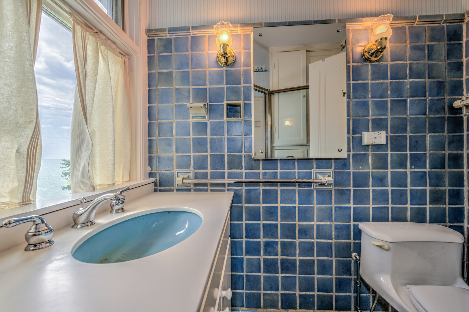 141 Sheridan Road Winnetka, IL 60093 - Photo 33 of 58 a bathroom with a double vanity sink a toilet a mirror and shower