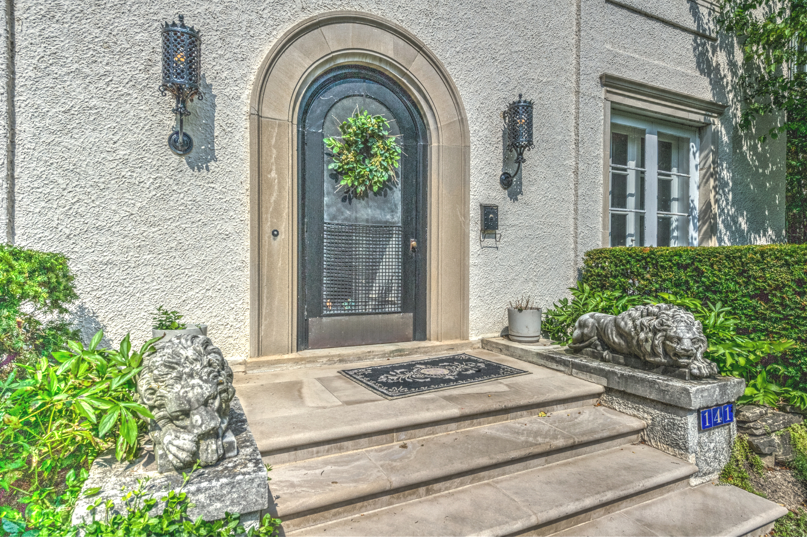 141 Sheridan Road Winnetka, IL 60093 - Photo 6 of 58 a front view of a house with a garden