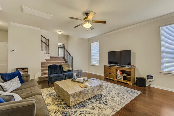 a living room with furniture a rug and a flat screen tv