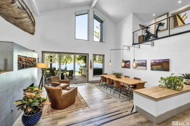a living room with fireplace furniture and a potted plant