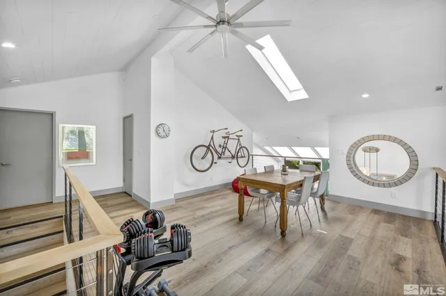 a view of a livingroom with furniture hardwood floor and a ceiling fan