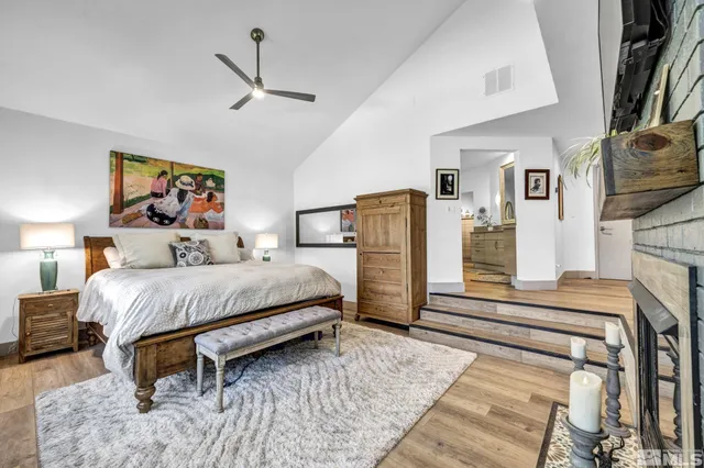 a bedroom with a bed painting and wooden floor