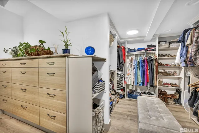 a view of walk in closet with clothes