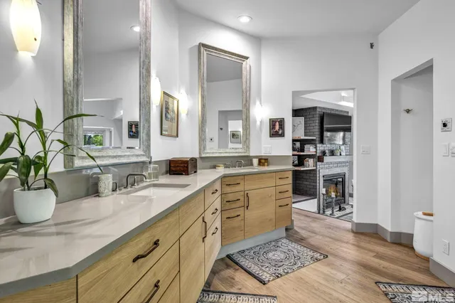 a large white kitchen with a sink stainless steel appliances and cabinets