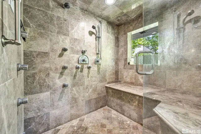a spacious bathroom with a granite countertop shower a mirror and a sink