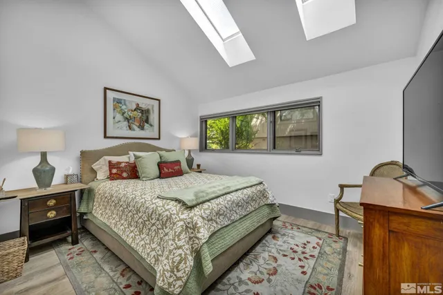 a bedroom with a bed and dresser with mirror