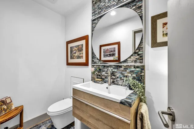 a bathroom with a sink a toilet and mirror