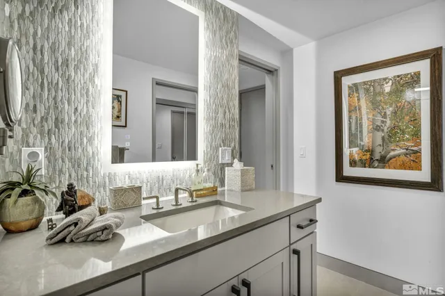 a bathroom with a sink double vanity and a mirror