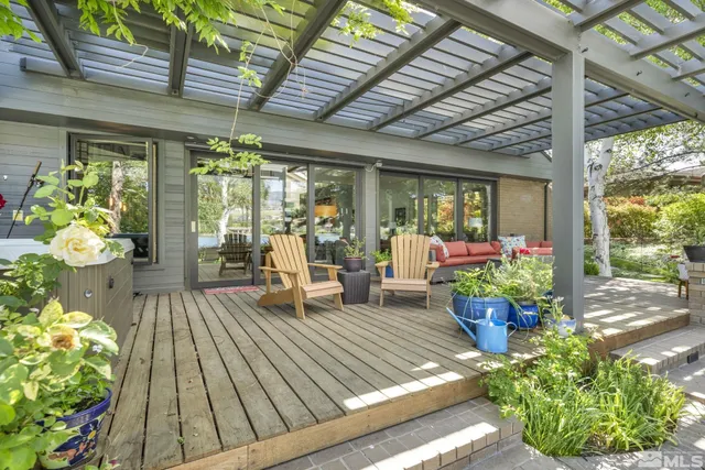 a living room filled with lots of potted plants