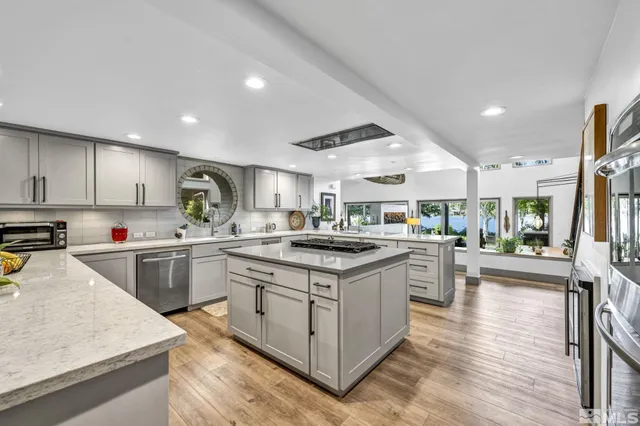 a kitchen with stove cabinets and wooden floor