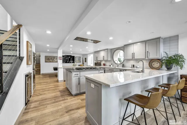a large white kitchen with lots of counter space a sink and appliances