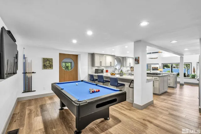 a living room with stainless steel appliances kitchen island granite countertop furniture and a view of kitchen