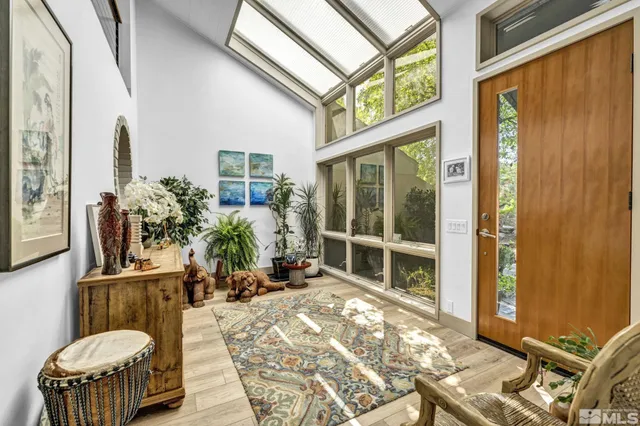 a living room filled with furniture and a potted plant