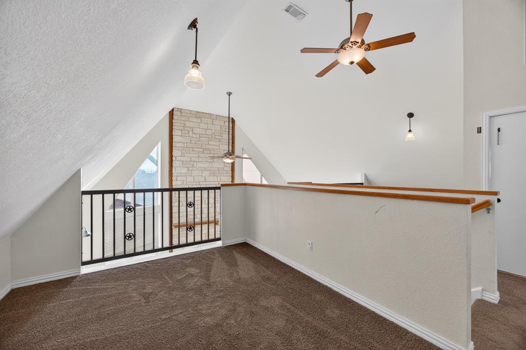 6775 Silver Creek Azle Road Azle, TX 76020 - Photo 14 of 40 Bonus room with a ceiling fan, lofted ceiling, and dark carpet