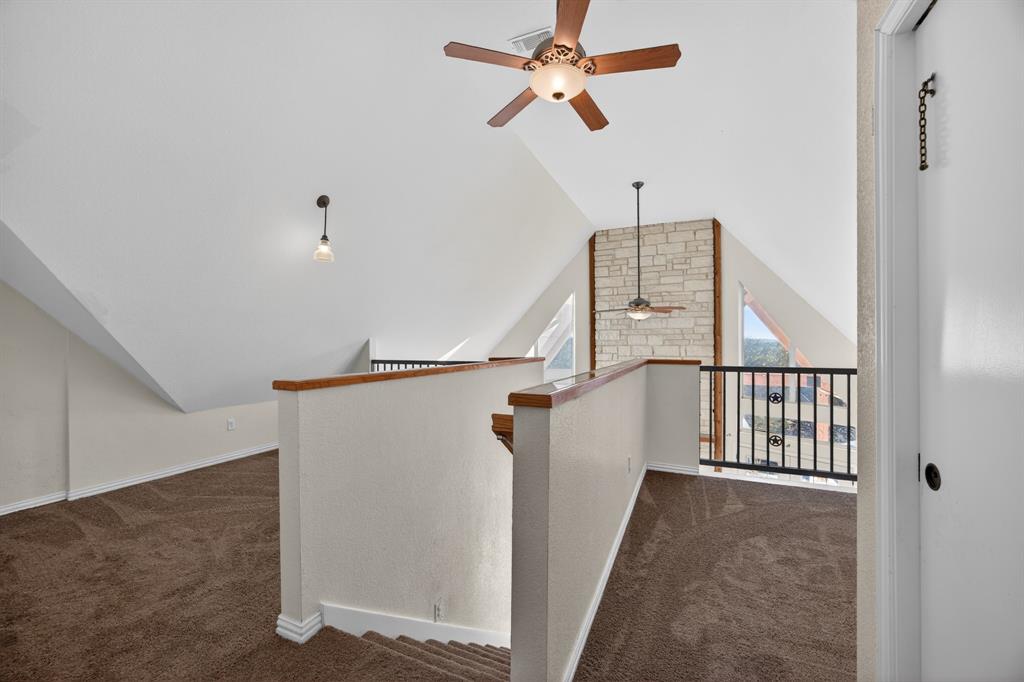 6775 Silver Creek Azle Road Azle, TX 76020 - Photo 15 of 40 Hallway with dark carpet and lofted ceiling
