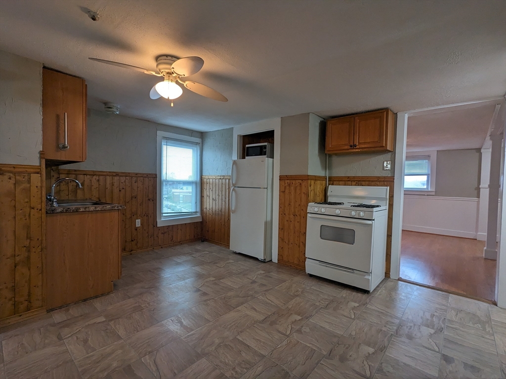 7 Congress Street, Unit 4 Milford, MA 01757 - Photo 2 of 11 a kitchen with a refrigerator and a stove top oven