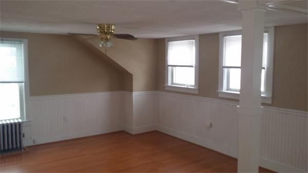 7 Congress Street, Unit 4 Milford, MA 01757 - Photo 5 of 11 an empty room with windows and chandelier fan