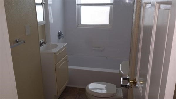 7 Congress Street, Unit 4 Milford, MA 01757 - Photo 8 of 11 a bathroom with a granite countertop toilet and a shower
