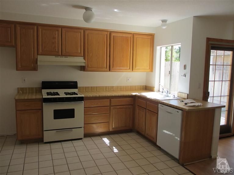 13556 East Quail Summit Road Moorpark, CA 93021 - Photo 2 of 8 a kitchen with a stove sink and cabinets