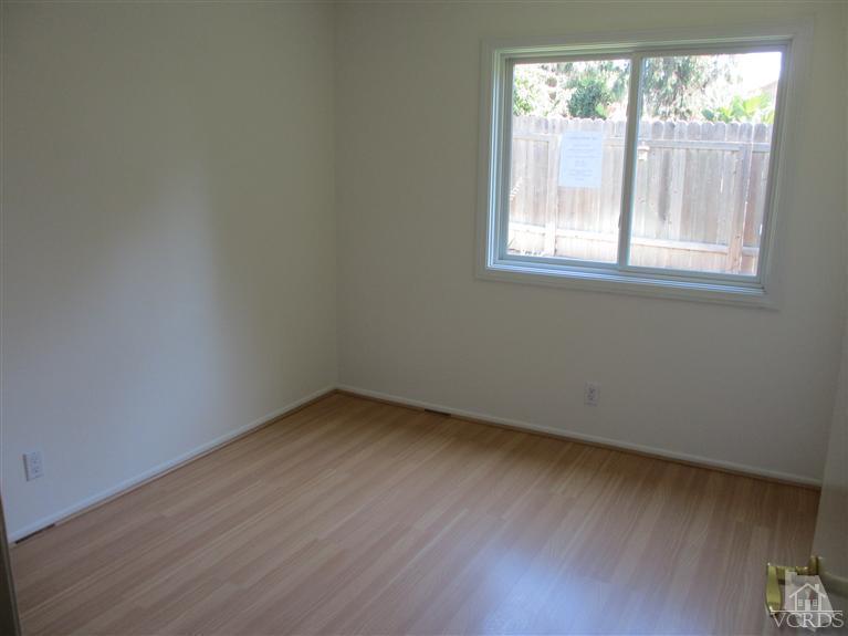13556 East Quail Summit Road Moorpark, CA 93021 - Photo 6 of 8 an empty room with wooden floor and windows
