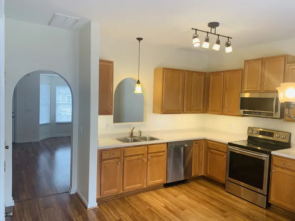 a kitchen with a sink appliances and cabinets