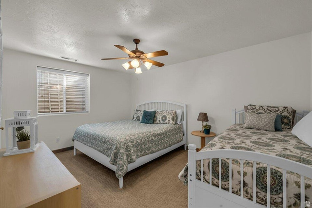841 1010 S Street St. George, UT 84790 - Photo 24 of 33 Carpeted bedroom featuring a textured ceiling and a ceiling fan