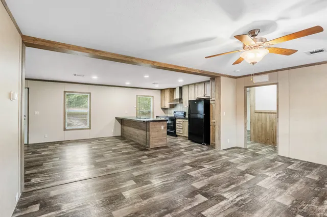 a view of a livingroom with a ceiling fan and window