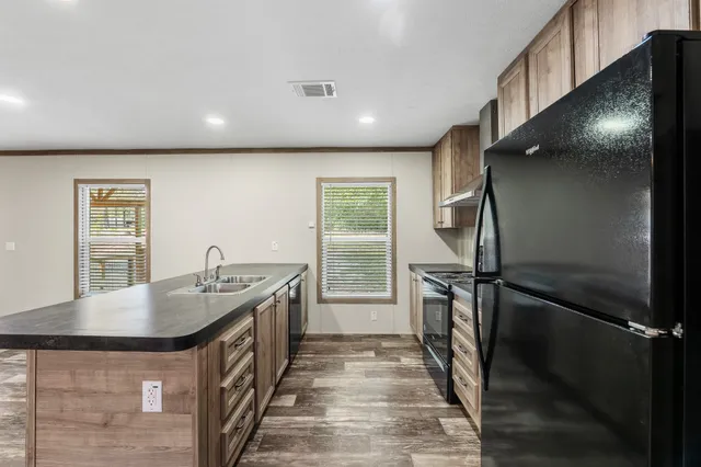 a kitchen with sink and mirror