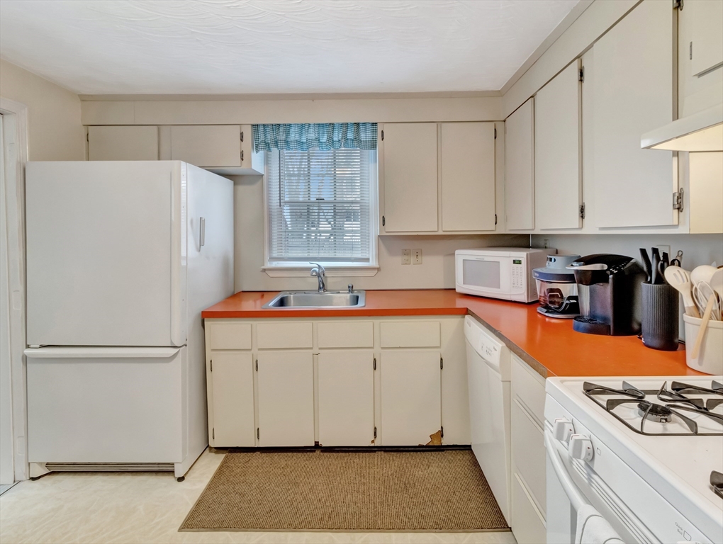 5 G Street Hull, MA 02045 - Photo 19 of 41 a kitchen with a refrigerator a stove a sink and cabinets