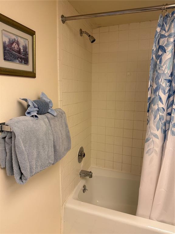 14950 Gulf Boulevard, Unit 805 Madeira Beach, FL 33708 - Photo 12 of 35 a bathroom with a bathtub and a shower