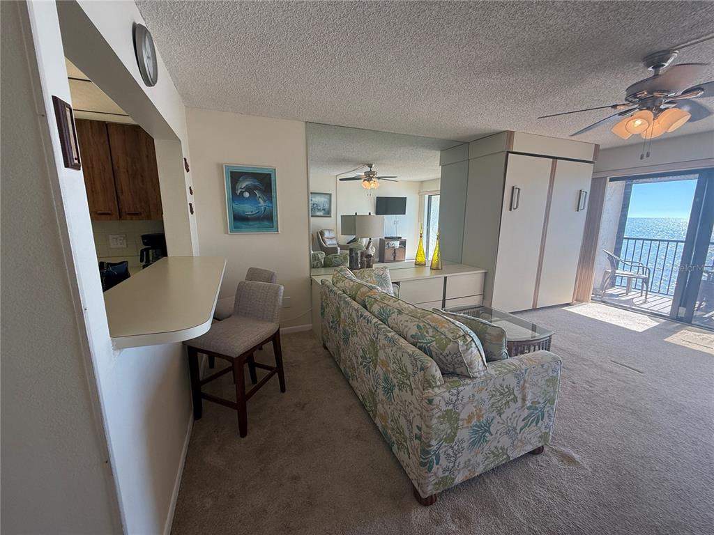 14950 Gulf Boulevard, Unit 805 Madeira Beach, FL 33708 - Photo 22 of 35 a living room with furniture and a flat screen tv