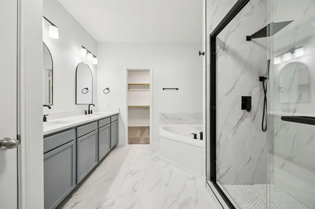 a spacious bathroom with a double vanity sink mirror double and shower