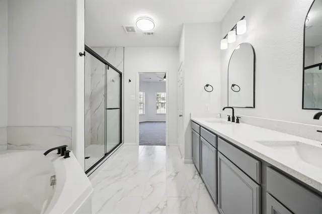 a spacious bathroom with a double vanity sink mirror and double