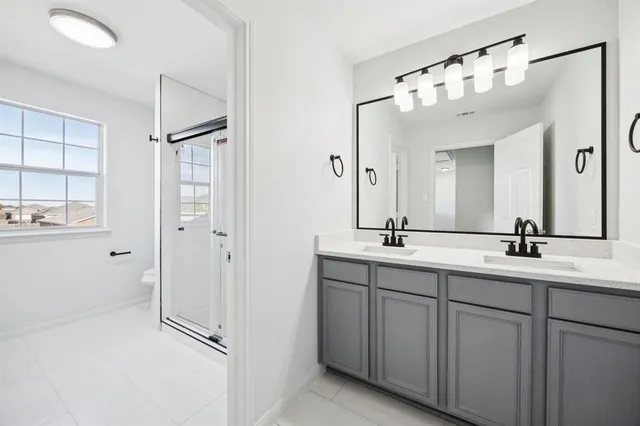 a bathroom with a double vanity sink mirror and double