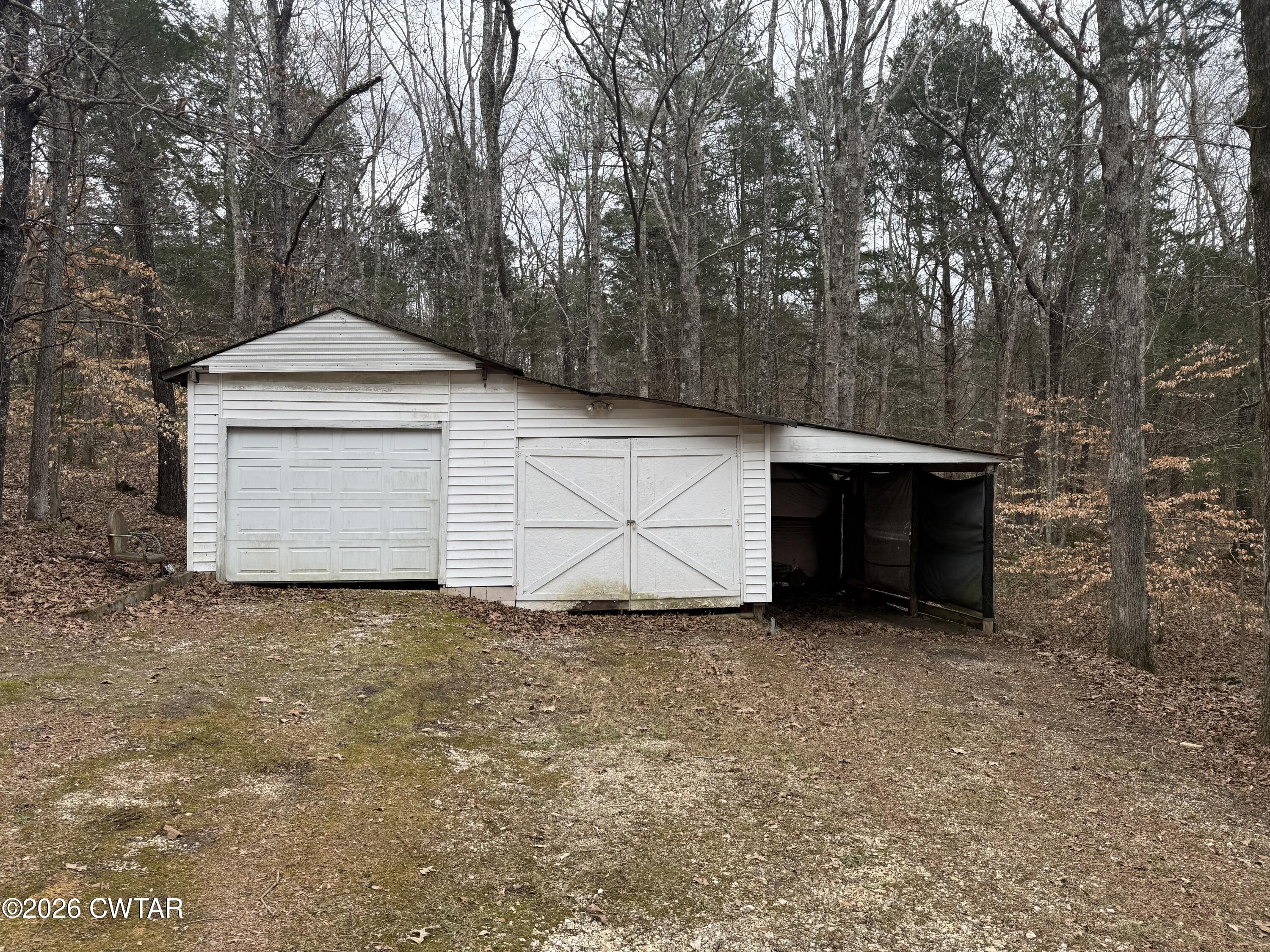 875 New Friendship Road Buena Vista, TN 38318 - Photo 7 of 13 a front view of a house with a yard and garage
