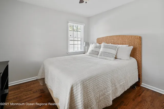 a large bed sitting in a bedroom next to a window