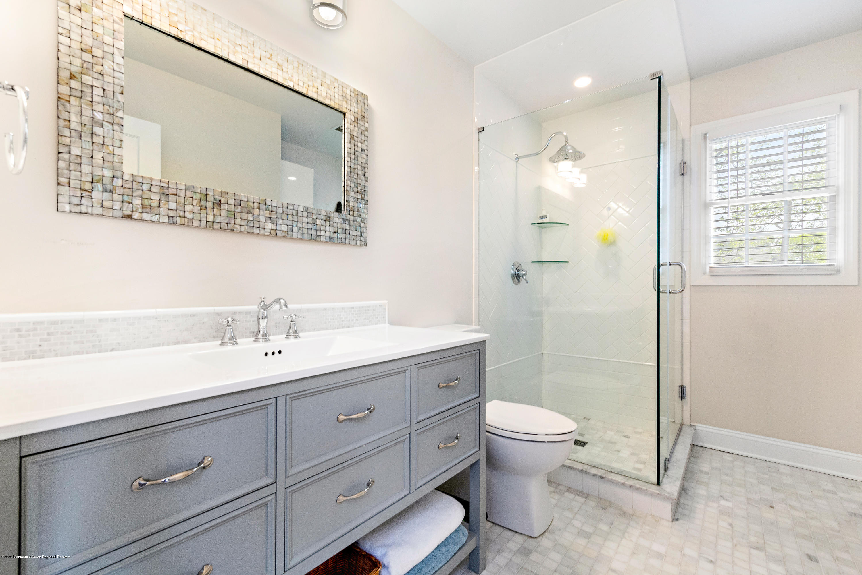 344 Euclid Avenue Manasquan, NJ 08736 - Photo 17 of 24 a bathroom with a granite countertop sink a toilet and a mirror